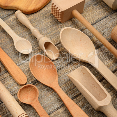 Set wooden kitchen utensils on wooden table.