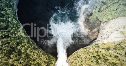 Waterfall that flows into a lake in a forest