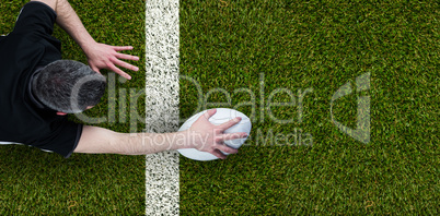 Composite image of a rugby player scoring a try