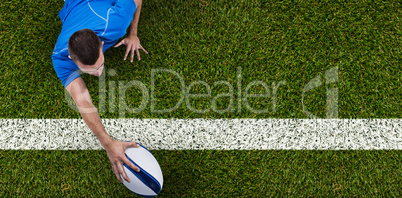 Composite image of rear view of rugby player lying in front with ball