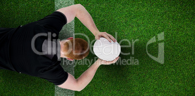 Composite image of rugby player about to throw a rugby ball