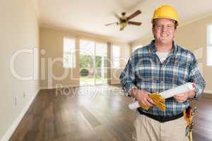 Contractor With Plans and Hard Hat Inside Empty Room with Wood F