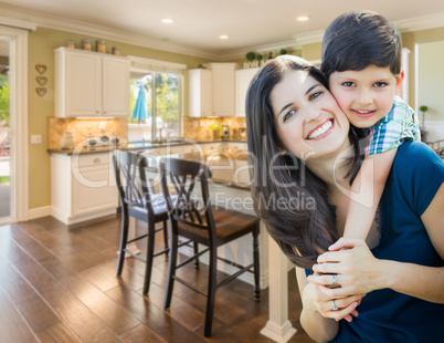 Young Mother and Son Inside Beautiful Custom Kitchen.