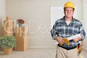 Contractor With Plans and Hard Hat Inside Empty Room with Moving