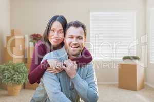 Mixed Race Caucasian and Chinese Couple Inside Empty Room with M