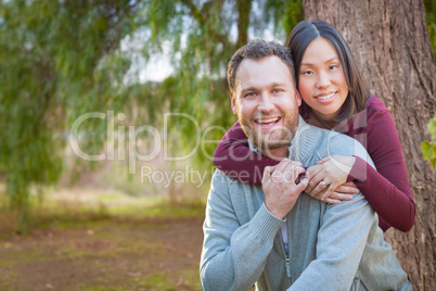 Mixed Race Caucasian and Chinese Couple Portrait Outdoors.