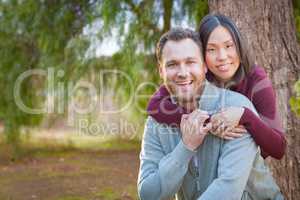 Mixed Race Caucasian and Chinese Couple Portrait Outdoors.