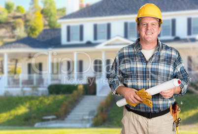 Contractor With Plans and Hard Hat In Front of Beautiful Custom