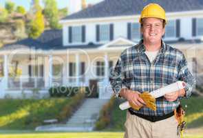 Contractor With Plans and Hard Hat In Front of Beautiful Custom