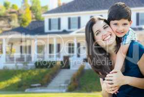 Young Mother and Son In Front Yard of Beautiful Custom House.