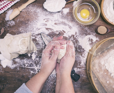 women's hands mix yeast dough from white wheat flour