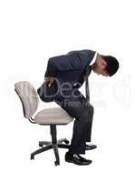 Man with back pain getting up from chair