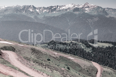 The mountainous landscape of the slopes covered by forest.