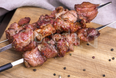 fried pieces of pork on skewers