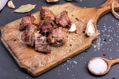 pieces of fried pork on a brown wooden board