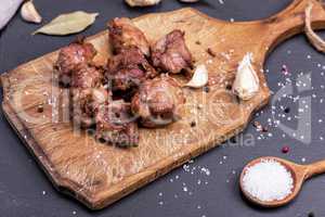 pieces of fried pork on a brown wooden board