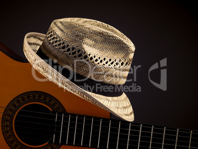 Straw hat with an acoustic guitar