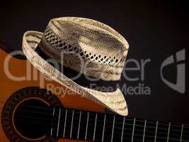 Straw hat with an acoustic guitar
