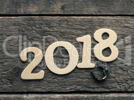 New Year 2018 with a horse shoe on wood