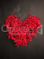 Shredded red paper shaped as a heart shape