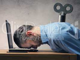 Business man sleeping on laptop