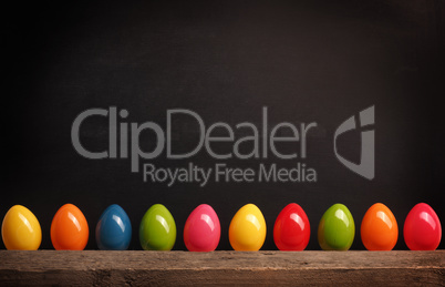 Plastic Easter eggs on a chalkboard