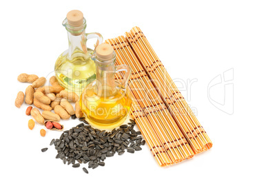 Peanuts, sunflower seeds and vegetable oils isolated on white ba