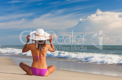 Rear View Beautiful Woman At Beach in Hat and Bikini