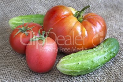 Tomatoes and cucumbers on the table on a linen cloth.