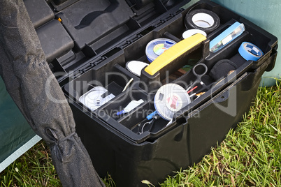 The items for fishing in the container.