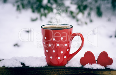 red mug with polka dots with hot black coffee