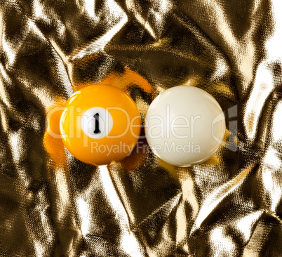 Billiard balls on golden surface.