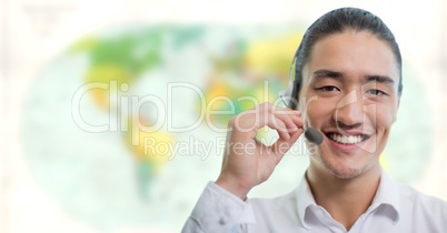 Travel agent man wearing headset in front of world map