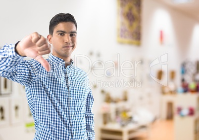 man in shop with thumbs down