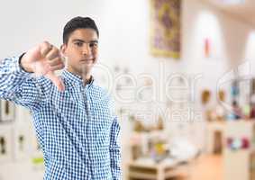 man in shop with thumbs down