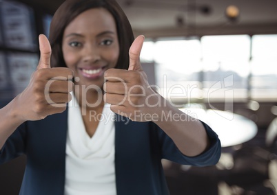 woman smiling with thumbs up