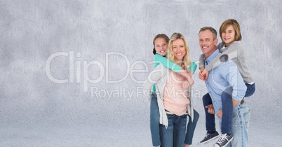 Family giving piggybacks and grey background