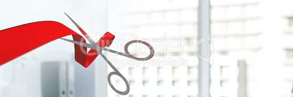 Scissors cutting ribbon with office windows of buildings