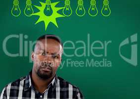 Confused man with bulbs on green background