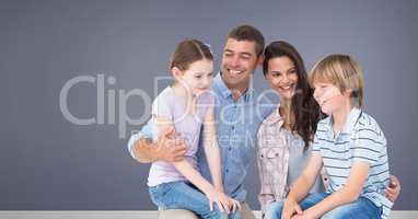 Family sitting together with purple background
