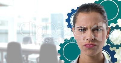 Confused woman in an office with blue cogs