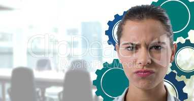 Confused woman in an office with blue cogs