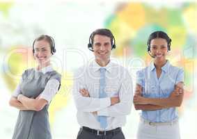 Travel agents wearing headsets in front of world map