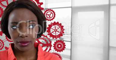 Confused woman in an office looking on the right with cogs