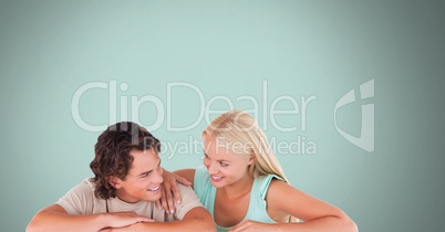 Couple laughing with blue background