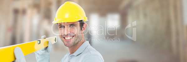 Construction Worker on building site holding spirit level