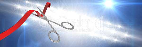 Scissors cutting ribbon with bright lights