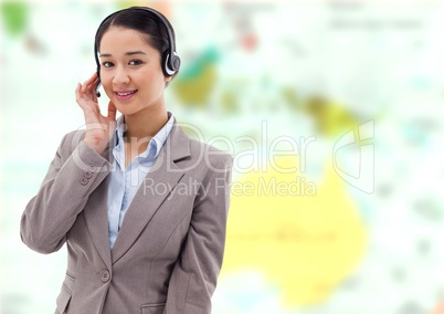 Travel agent woman wearing headset in front of world map