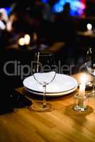 Empty glass on table in night club or restaurant, closeup