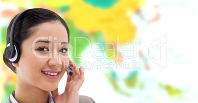 Travel agent woman wearing headset in front of world map